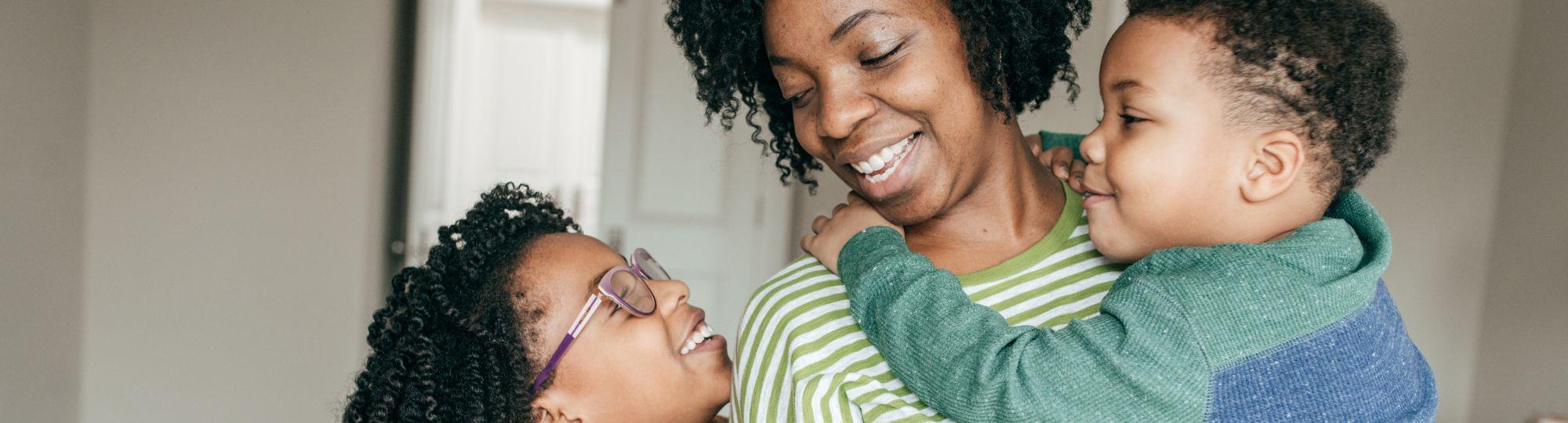 Photo of smiling mother and two children